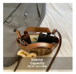 Internal capacity of kids plaid bucket bag showing storage for phone and accessories