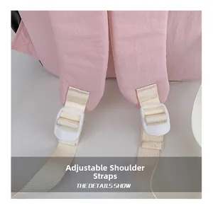Close-up of pink backpack showing adjustable straps and white plastic buckle details