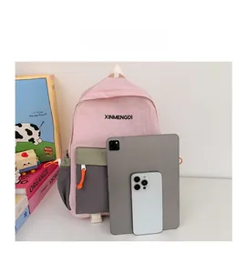 Size comparison showing the pink and green contrast backpack next to a tablet and phone