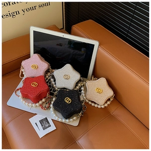 Detailed view of mini star-shaped handbags with pearl handles and chain straps in five colors