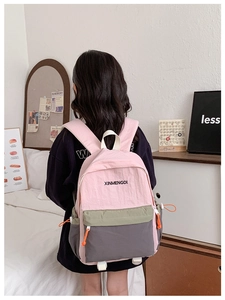 Detail of three-color stitching nylon backpack with XINMENGDI logo and side drawstring