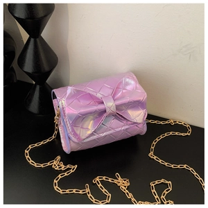 Macro detail of purple laser mini crossbody bag with bow decoration and golden chain