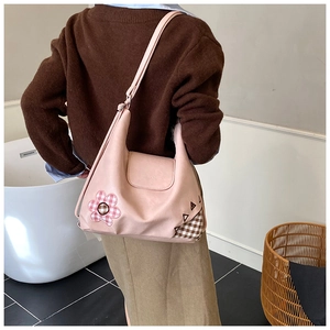 Detail of pink floral hobo bag for girls featuring patchwork flowers and adjustable strap