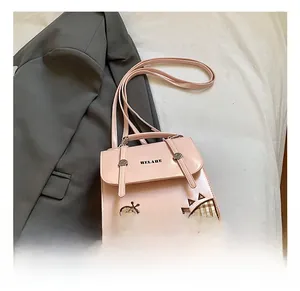 Detail showing pink leather backpack with ladybug print and soft checkered pattern