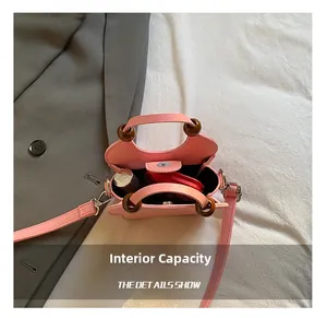 Pink mini crossbody bag interior showing storage for lipsticks and small cosmetics