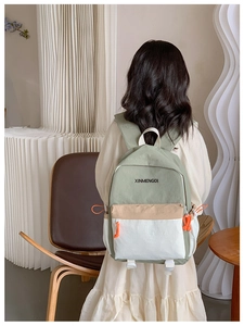 Detail view of the tricolor patchwork kids backpack featuring adjustable orange drawstrings