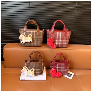 Close-up of plaid tweed tote bags with PU leather handles and cute plush horse charms