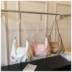 Close-up of small crossbody bags for girls in white pink and brown with floral details