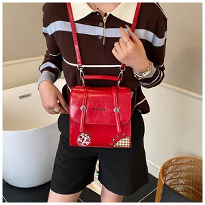 Detail of red PU leather child backpack featuring cartoon ladybug and HEHLAHE logo