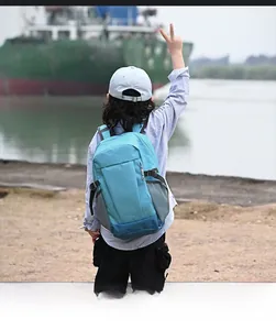 Detailed back view of outdoor kids backpack featuring blue contour mountain graphics