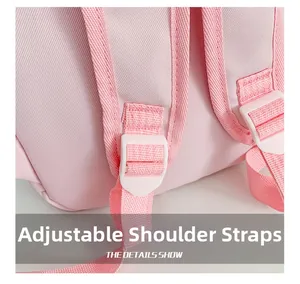 Detail of adjustable pink woven shoulder strap with white plastic buckle on kids backpack