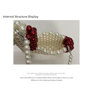 Detail view of the hand-woven red and white pearl mini bag showing internal structure