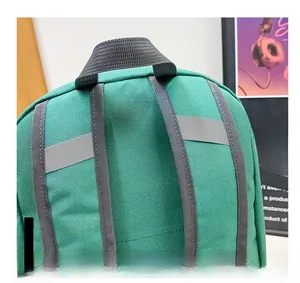 Detail of green backpack featuring reflective safety strips and adjustable nylon straps