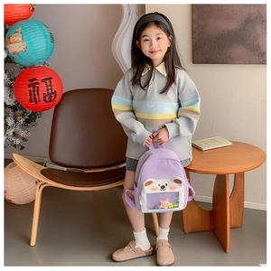Detail of light purple children's backpack with cute 3D bear and clear window display