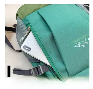 Close-up of the front zipper pocket on children's emerald green outdoor backpack