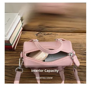 Detail view of pink cylinder bag internal capacity with silver hardware and PU leather