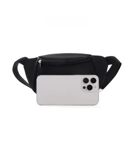 Size comparison of the black nylon kids crossbody bag with a white smartphone