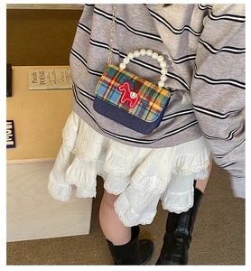 Detail of kids plaid handbag with pearl handle, pony embroidery and metal chain
