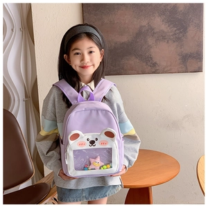 Detail of light purple toddler backpack featuring a cute 3D bear pocket with a clear window