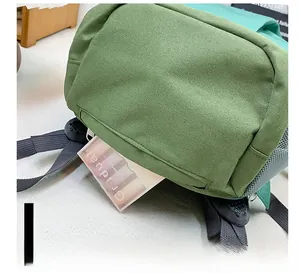 Detail view of the hidden bottom zipper pocket on this canvas outdoor kids backpack