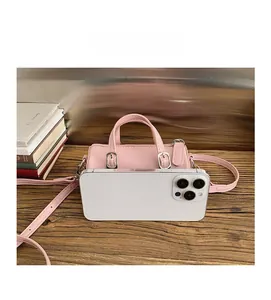 Size comparison of the pink mini cylinder bag next to a smartphone showing compact scale