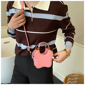 Detail of pink star-shaped mini bag with wooden bead handles and adjustable strap