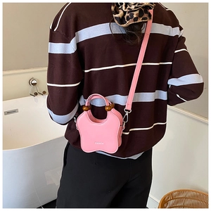 Pink butterfly-shaped leather mini bag featuring wooden bead handle and crossbody strap