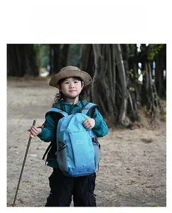 Detail of blue outdoor backpack showing breathable mesh side pocket and buckle closure
