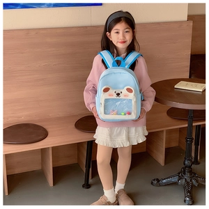 Detail of light blue kids backpack featuring clear PVC window and cute polar bear design
