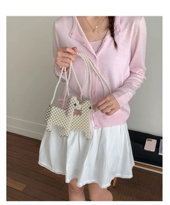 Close-up of handmade white pearl woven alpaca shoulder bag for girls with beaded strap