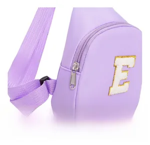 Close-up of smooth silver metal zipper and durable nylon fabric on purple kids chest bag