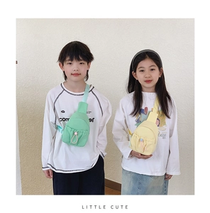Close-up of mint green and yellow kids' crossbody bags featuring adjustable drawstrings