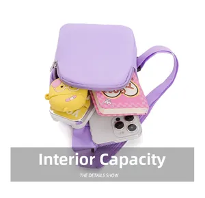 Detail of the purple crossbody bag's internal capacity with phone and accessories