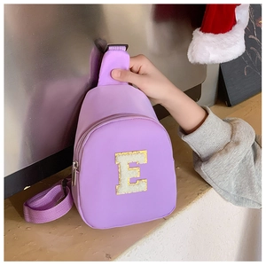 Detailed close-up of a purple nylon kids chest bag with embroidered letter E patch