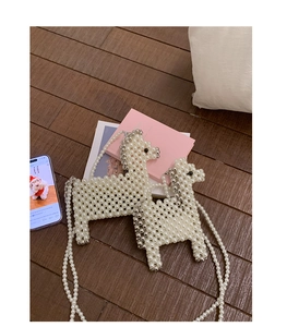 Detail of handmade pearl alpaca shaped crossbody bags for kids in white and silver beads