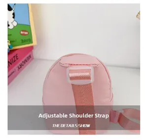 Close-up of pink kids chest bag featuring adjustable shoulder strap and plastic buckle