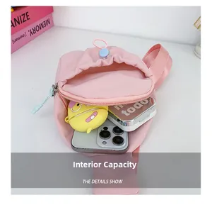 Pink nylon kids crossbody bag showing internal space for a phone and earphone case