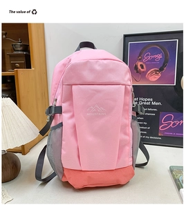 Detailed view of pink and coral backpack side with mesh pocket and compression strap