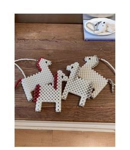 Détail de sacs à perles en forme de cheval faits main avec crinières rouge et argent