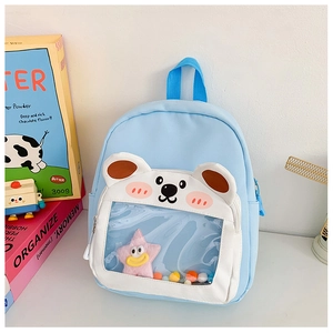 Detail of light blue backpack with bear-shaped transparent window and plush star decor