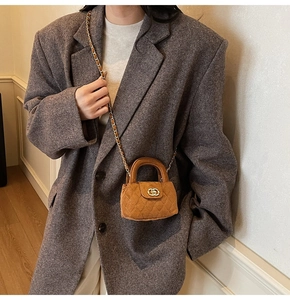 Close-up of brown quilted velvet mini bag with gold-tone hardware and chain strap