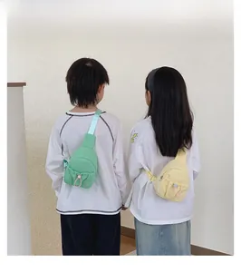 Kids' crossbody chest bag in mint green and lemon yellow with drawstring front pockets