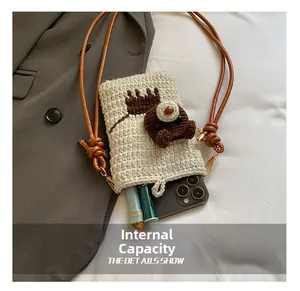 Detailed internal capacity showing room for a smartphone and lipstick in a knit bag