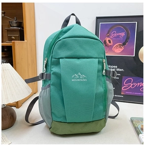 Detail of teal and olive green hiking backpack with mesh side pockets and adjustable side straps