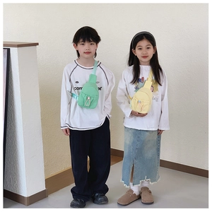 Kids minimalist chest bag in mint green and soft yellow shown on child models