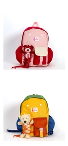 Detail of kids backpacks with contrast colors, front flap pocket and plush bear toy