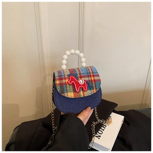 Detail of mini plaid handbag with horse patch and elegant white pearl handle