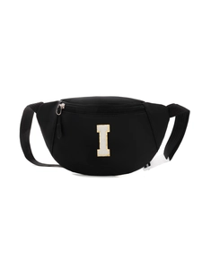 Detail of black nylon kids chest bag featuring sequined letter I patch and adjustable strap