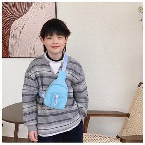 Light blue nylon kids chest bag featuring a front drawstring pocket and pink toggle