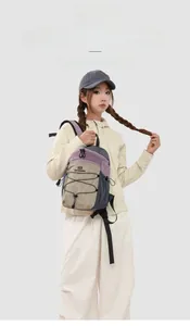 Detail view of colorful nylon hiking backpack with elastic drawstrings and logo